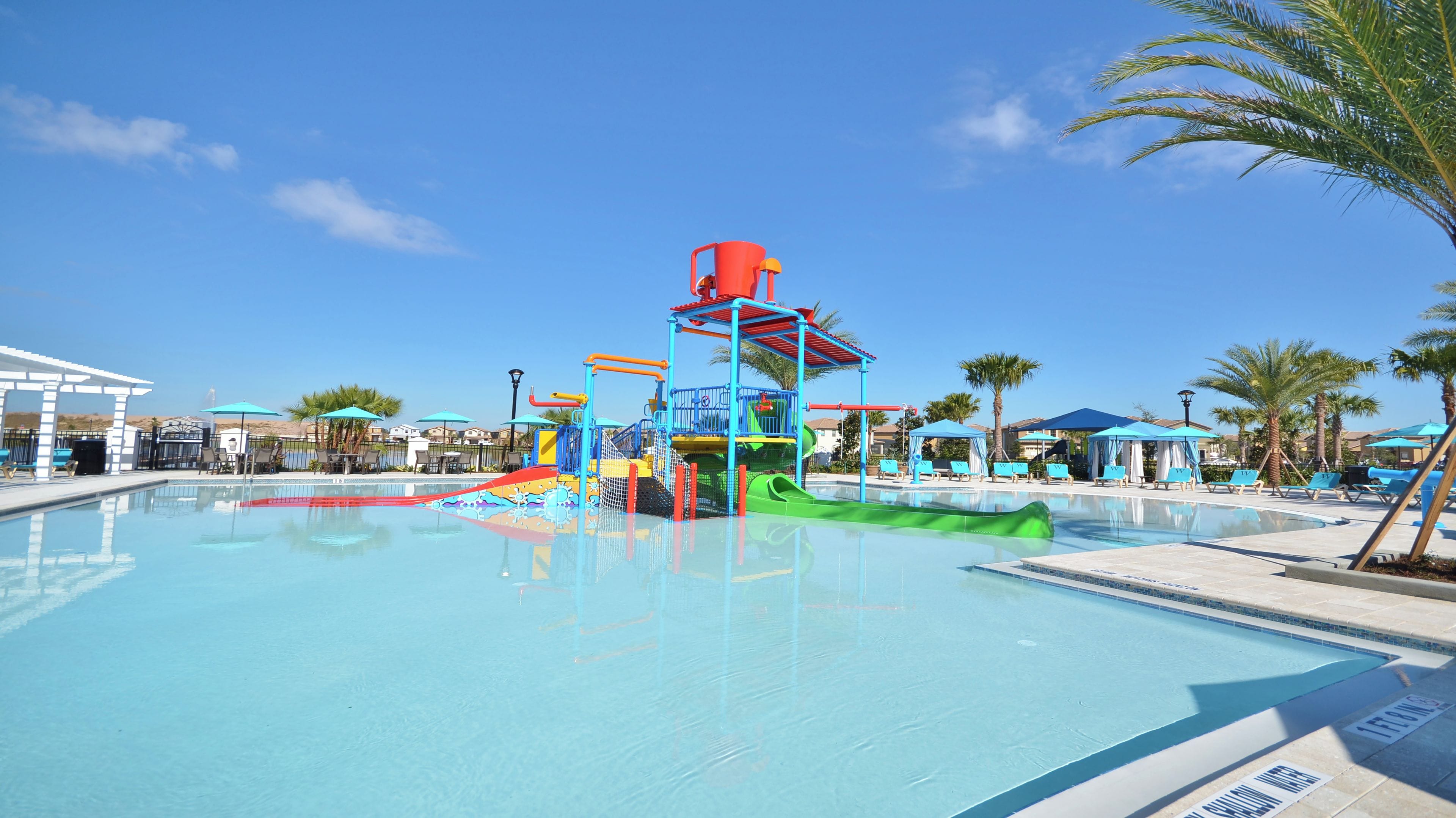 A swimming pool with a water park area, including slides and play structures.
