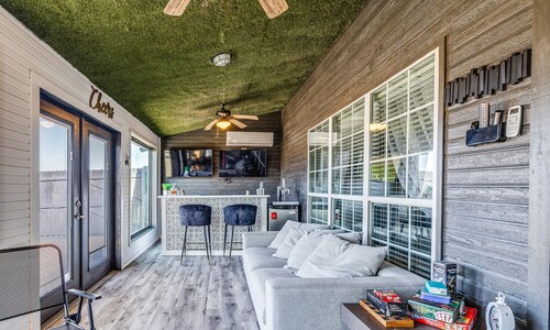 Stylish corner home with cozy interiors, a private bar, and inviting charm