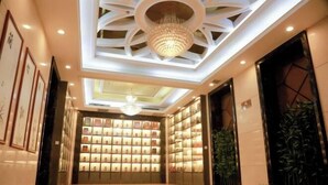 A hotel lobby with a chandelier, bookshelves, and framed artwork on the walls. - Four Seasons Hotel (Taiyuan l Liuxiang Shanxi Medical University Second Hospital) (Taiyuan)