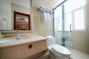 A bathroom with a marble sink, a toilet, a glass shower enclosure, and a towel rack. - Four Seasons Hotel (Taiyuan l Liuxiang Shanxi Medical University Second Hospital) (Taiyuan)