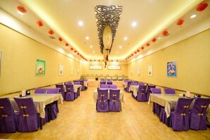 A banquet hall with multiple tables and chairs, a central aisle, and a decorative ceiling. - Four Seasons Hotel (Taiyuan l Liuxiang Shanxi Medical University Second Hospital) (Taiyuan)