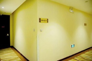 A hotel hallway with a carpeted floor, a sign indicating room number 301, and a light switch on the wall. - Four Seasons Hotel (Taiyuan l Liuxiang Shanxi Medical University Second Hospital) (Taiyuan)