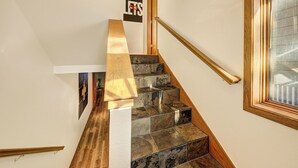 A staircase with wooden handrails and stone steps. - Gorgeous Remodeled 3-Bedroom home in charming downtown Frisco with Private Sauna (Frisco)