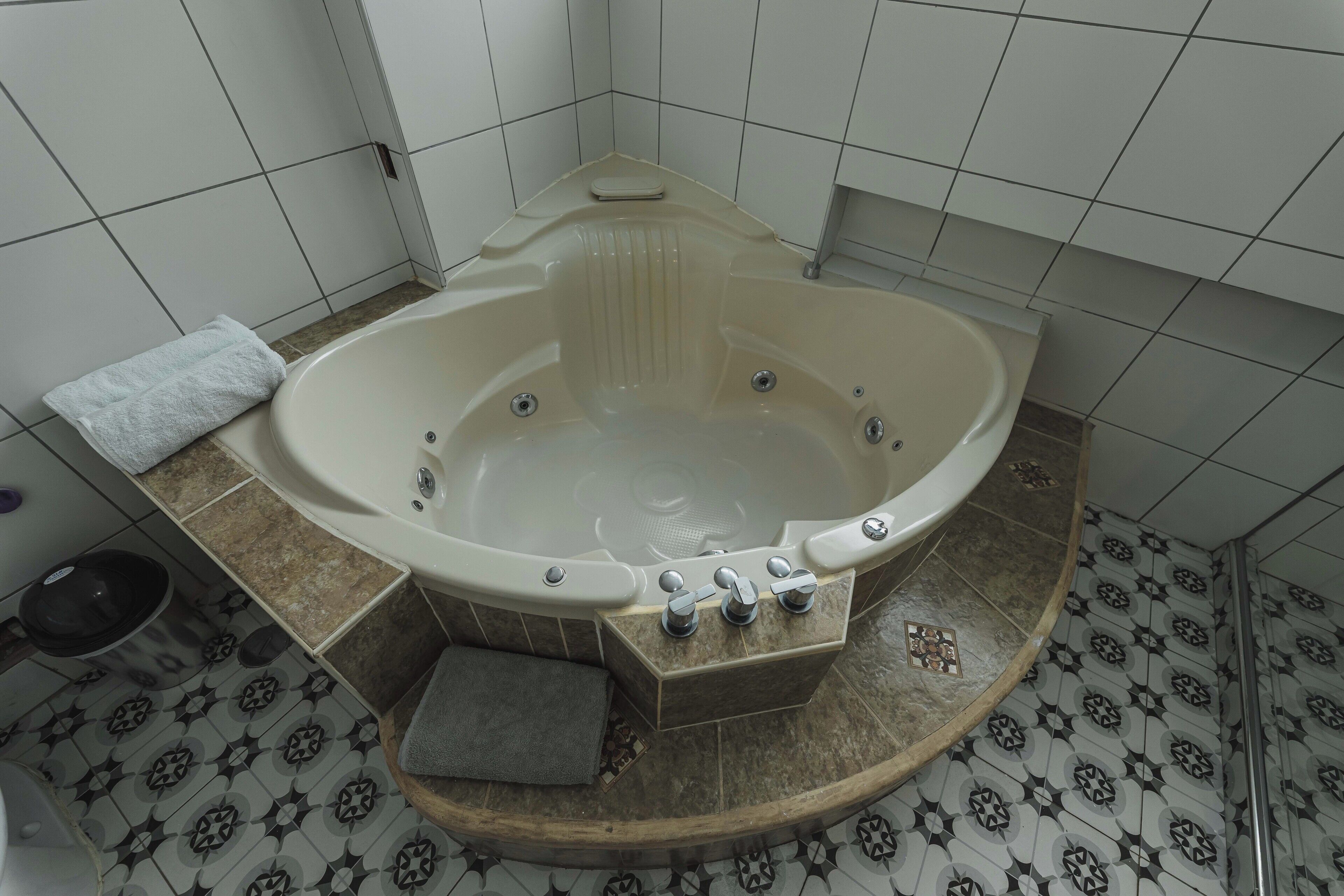 A bathroom with a freestanding bathtub, a toilet, and a sink.