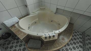 A bathroom with a freestanding bathtub, a toilet, and a sink.