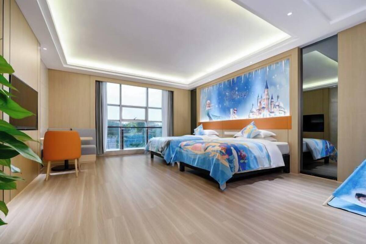 A modern hotel room with a large bed, a window, and a painting of a castle.
