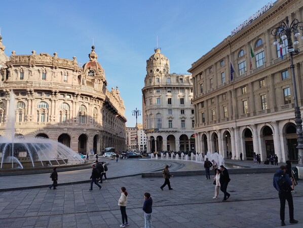 A public square with historic buildings, a fountain, and people walking. - Rubatto House, Genoa center. strategically located near the Aquarium (Genova)