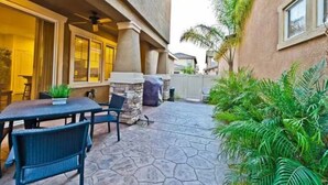 A patio with a stone floor, outdoor seating, and a stone fireplace. - 3Bedroom House in a family orientated neighborhood (Chula Vista)
