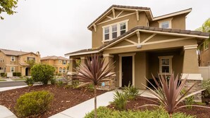 A two-story house with a stone facade and a pitched roof. - 3Bedroom House in a family orientated neighborhood (Chula Vista)
