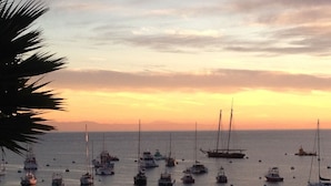 A marina with multiple boats docked at sunset.