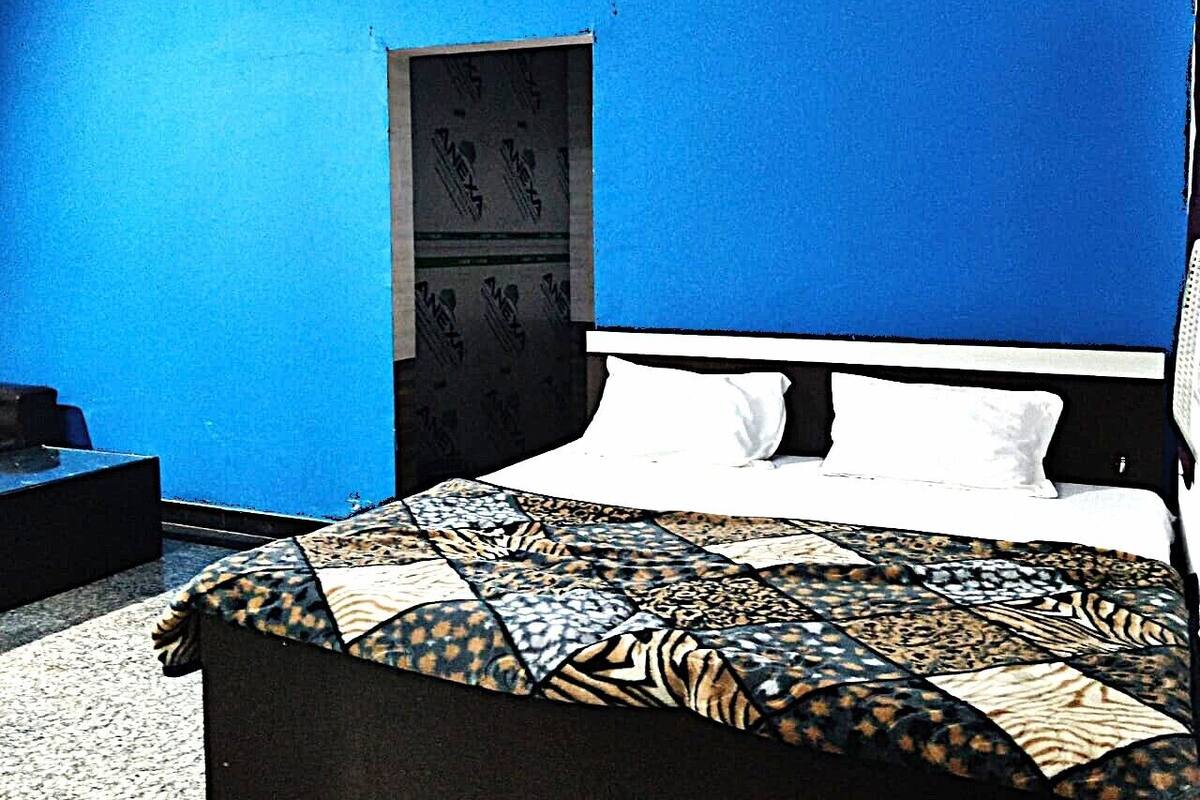 Une chambre à coucher avec un lit, une table de chevet et une armoire.