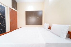 A bedroom with a bed, a wardrobe, and a door. - Medhaa Homes Madurai (Madurai)