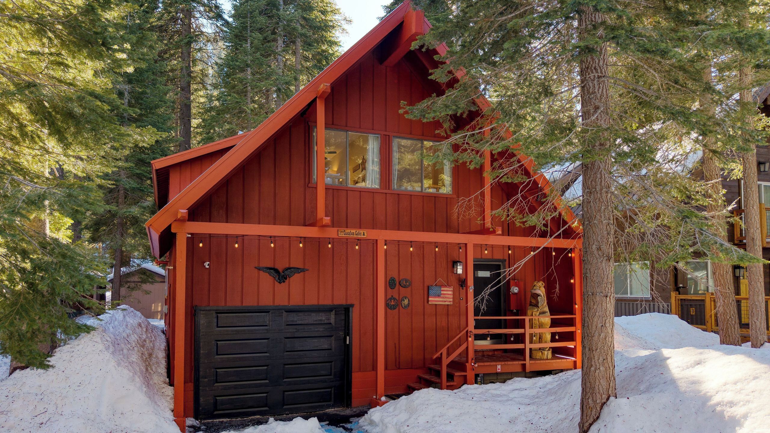 A cabin with a black door, a staircase, and a sign indicating it is a cabin.