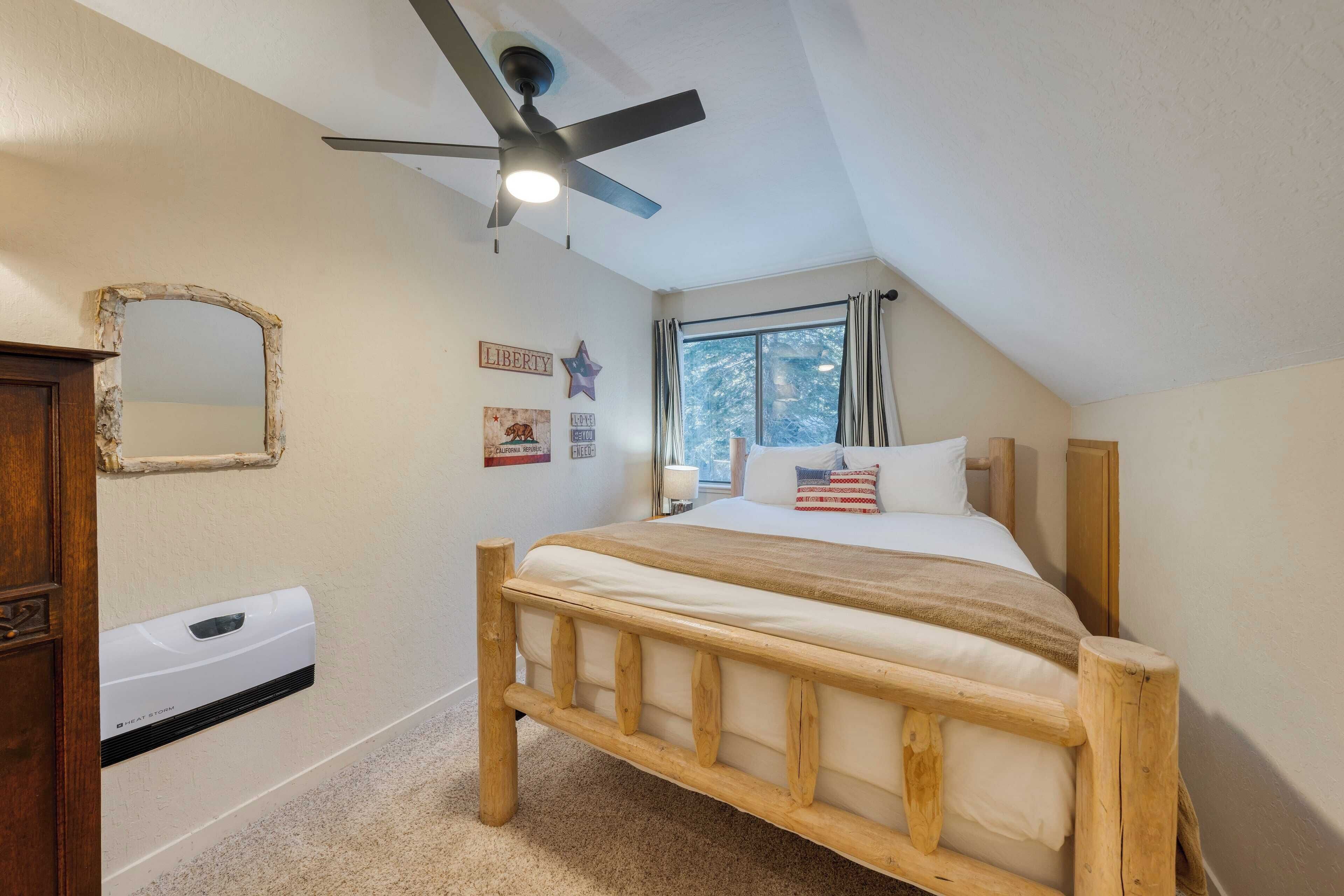 A bedroom with a wooden bed, a ceiling fan, a window with curtains, and a wall-mounted heater.