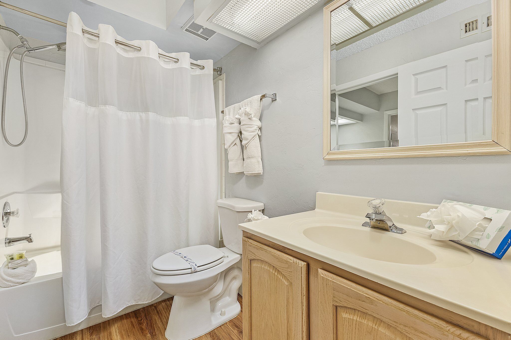 A bathroom with a bathtub, toilet, and sink.