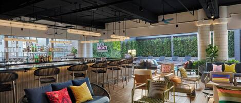 A modern bar area with seating and a bar counter.