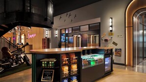 A bar area with a neon sign, a motorcycle, and a vending machine. - New Hotel Moxy Montreal Downtown (Montreal)