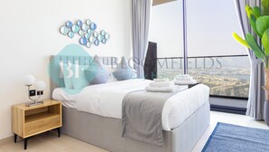 A modern bedroom with a large bed, a nightstand, a decorative wall piece, and a view of the city through large windows. - Bloomfields Modern 1Br Bingahtti Onyx (Dubai)