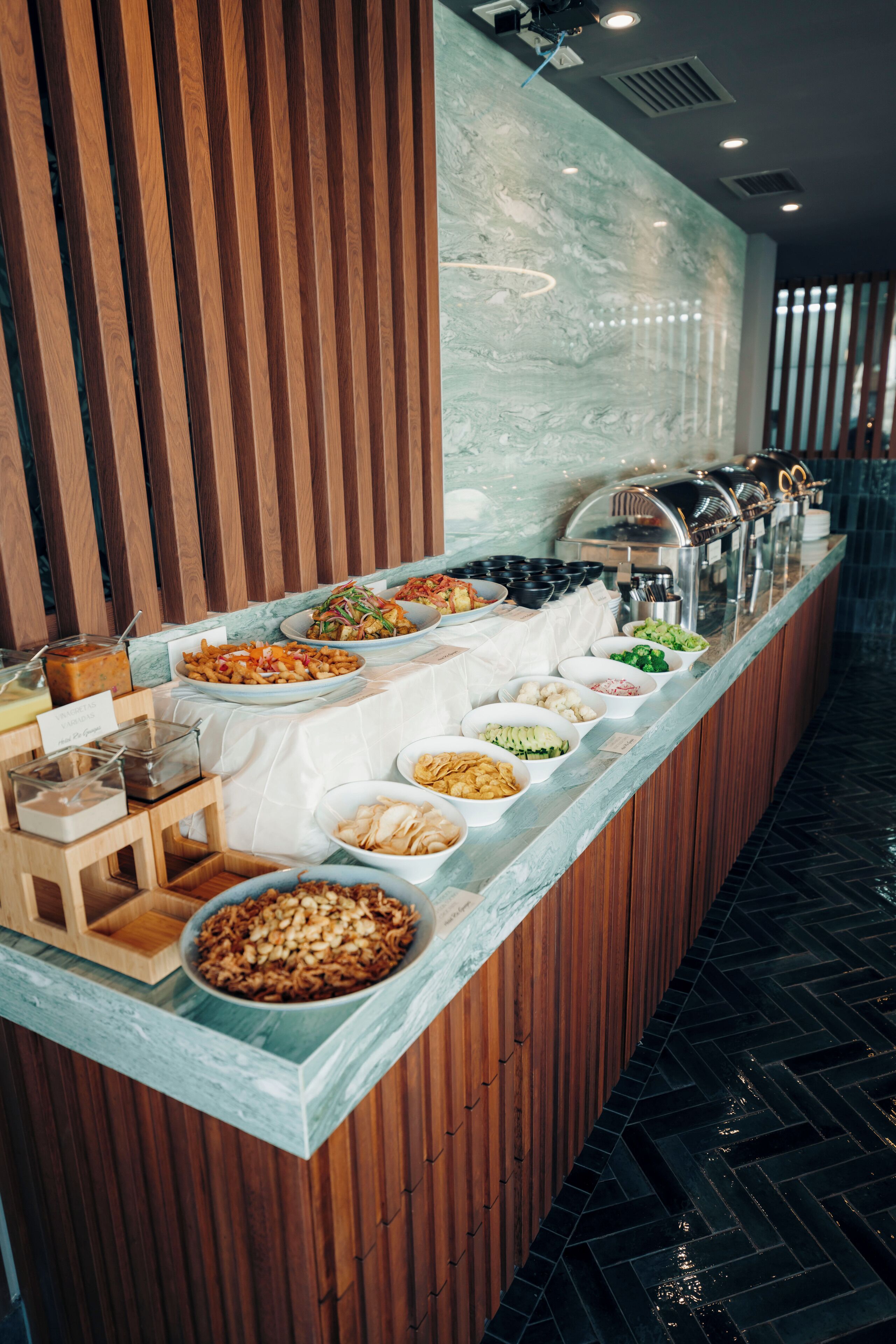 Un buffet proposant une variété de plats et un mur recouvert de panneaux en bois.