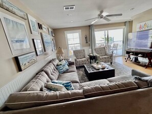 A living room with a sofa set, a coffee table, and a television.