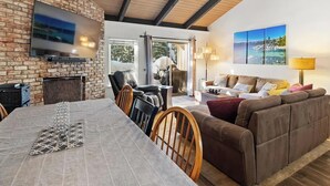 A spacious living area with a dining table, leather chairs, a brown sofa, and a fireplace. - *Special* Lake~Hiking~Pool~Tahoe Townhome (Incline Village)