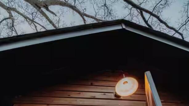A wooden cabin with large windows, a door leading inside, and a ceiling light. - Charming, bungalow + hot tub in NODA district of Charlotte. 10 min f/uptown. (Charlotte)