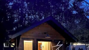 A rustic cabin with a stone pathway leading to the entrance, a wooden door, and a small porch area. - Charming, bungalow + hot tub in NODA district of Charlotte. 10 min f/uptown. (Charlotte)