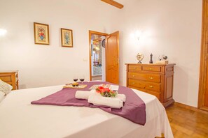 Een hotelkamer met een bed, een kaptafel en twee ingelijste foto's aan de muur.