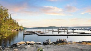 A marina with docks, boats, and a natural landscape with trees and hills in the background. - Dwntwn CDA Historic Remodel - Walk to Lake with Hot Tub! (Coeur d'Alene)