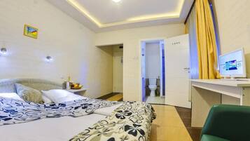 Relax in a stylish room with a large bed, desk, and modern amenities.