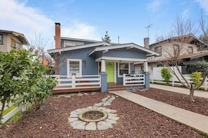 A residential house with a front porch, a green door, and a white fence. - Le Willow-Vintage/Modern Design (Modesto)