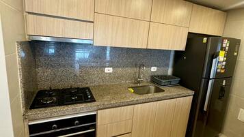Fridge, coffee/tea maker, cookware/dishes/utensils