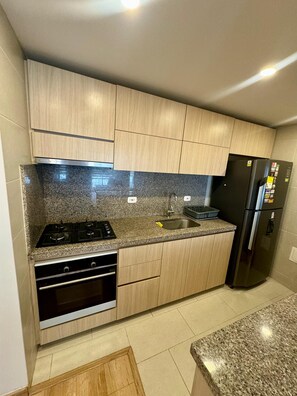 Fridge, coffee/tea maker, cookware/dishes/utensils