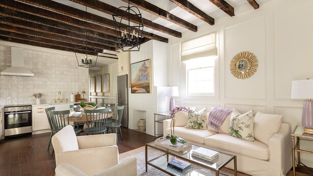 A spacious living room with a high ceiling, a dining area, and a kitchen. - Newly Restored Historic Home, Close to King! (Charleston)