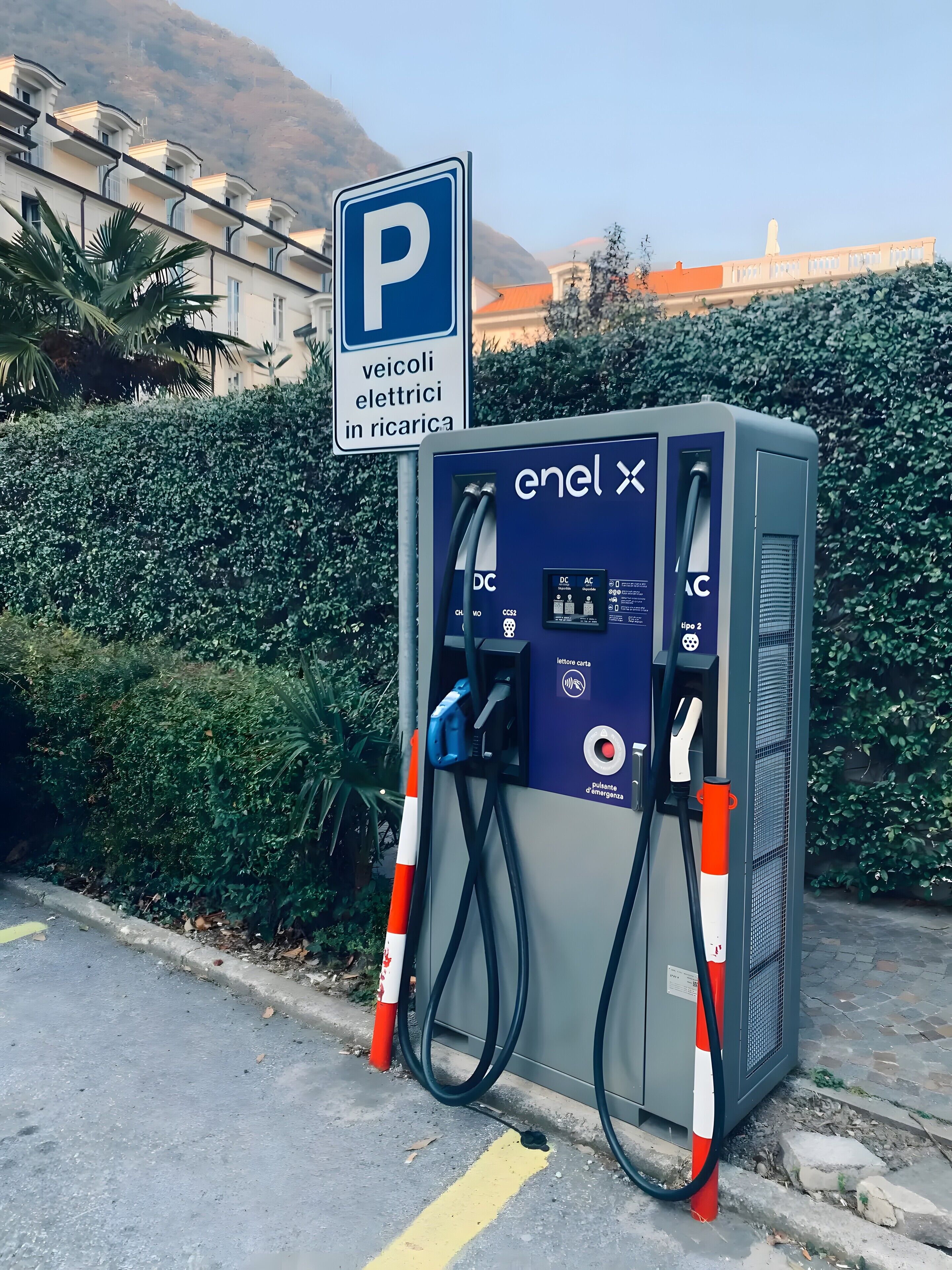 A public electric vehicle charging station with a sign indicating parking for electric vehicles.