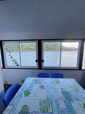 Enjoy a serene view of the water and lush surroundings from this room's large window.