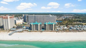 A coastal hotel with multiple high-rise buildings, beachfront properties, and a sandy beach.