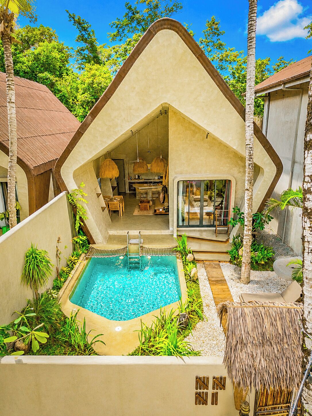 A modern villa with a swimming pool, a dining area, and a living room.