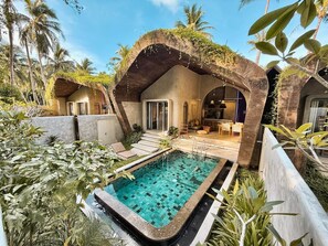 A pool area with a tiled deck, a covered seating area, and a view of the pool. - Diwatu Villas El Nido (El Nido)