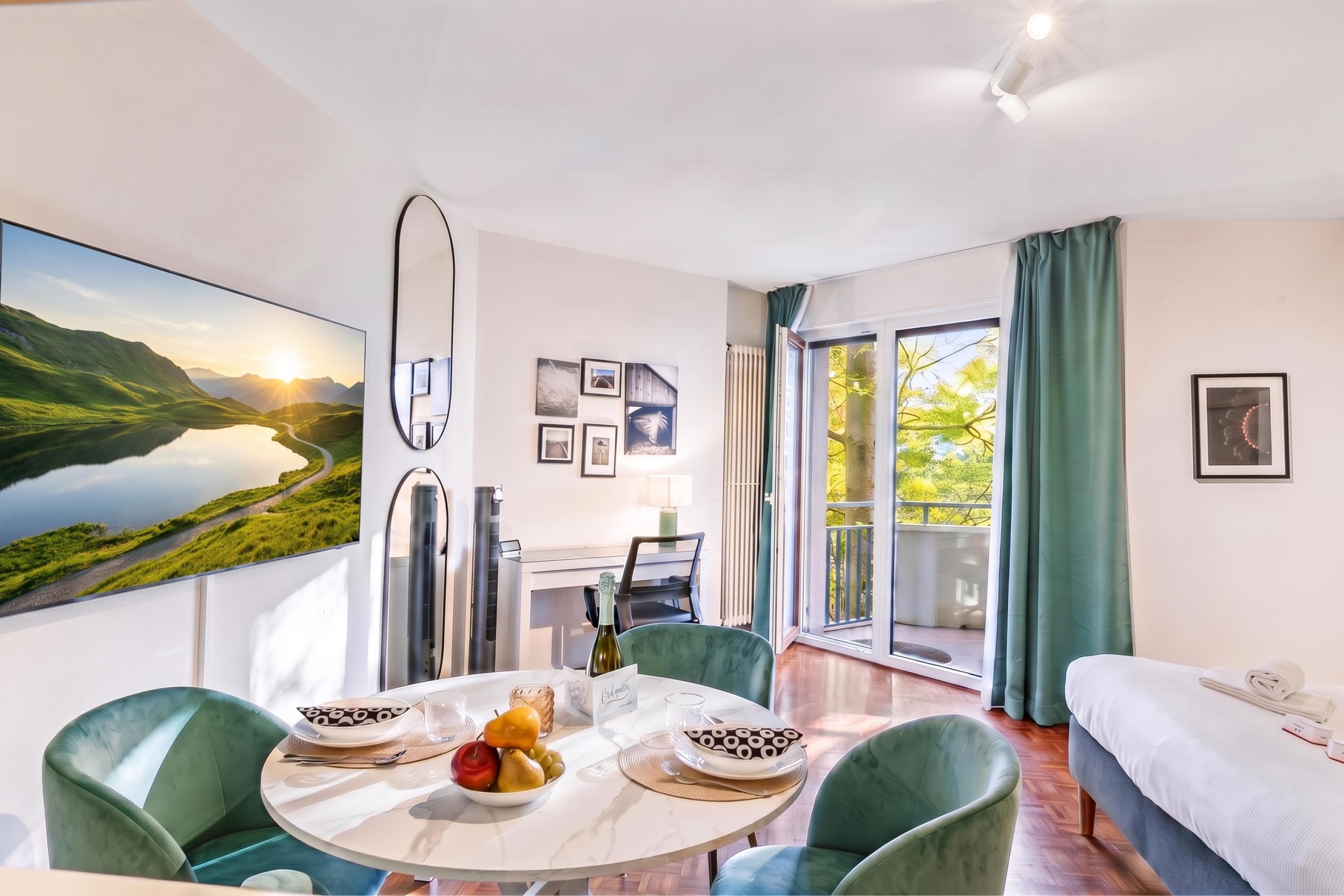 A modern hotel room with a dining area, a bed, and a balcony with a view of the outdoors.