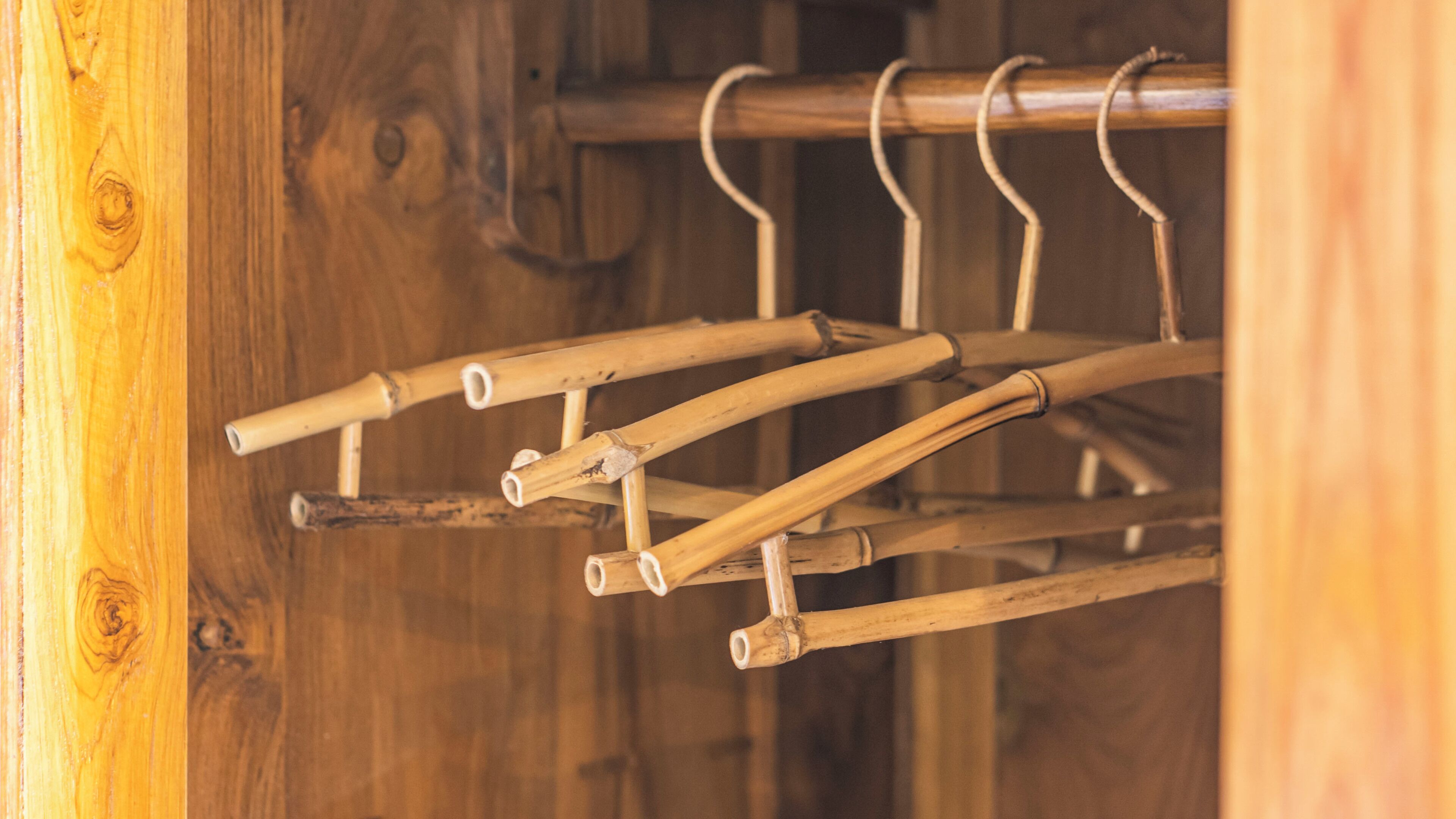A wooden rack with multiple hangers.