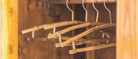 A wooden rack with multiple hangers.