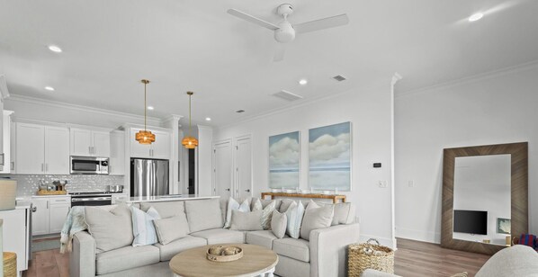 A modern living room with a sectional sofa, a coffee table, and a TV.