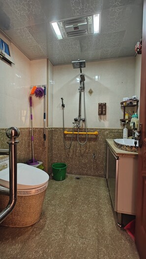 A bathroom with a shower, toilet, and sink. - Mommy's home with breadfast and more (Qingdao)