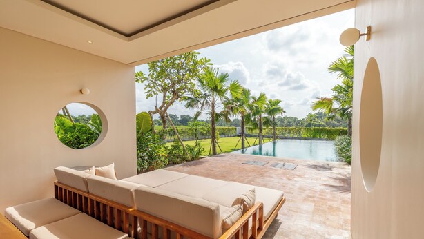 A modern bedroom with a large window overlooking a pool and lush greenery. - Atelier Home by Great Bali Villas (Selemadeg)