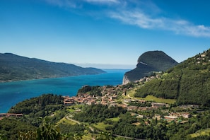 A coastal town with buildings on a hillside overlooking a large body of water. - Casa Panorama in Tremosine With View Terrace (Tremosine)