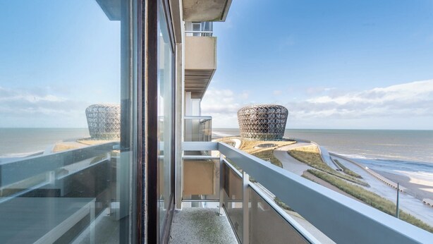 A modern building with a glass balcony overlooking a beach and distinctive spherical structures. - Family spot by the coastal trails (MIDDELKERKE)
