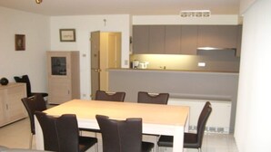A modern kitchen with a dining area. - Apartment in Middelkerke near the Beach (MIDDELKERKE)