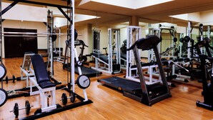 A gym with various exercise equipment, including treadmills, weight machines, and free weights. - AIGES MELATHRON (Veroia)
