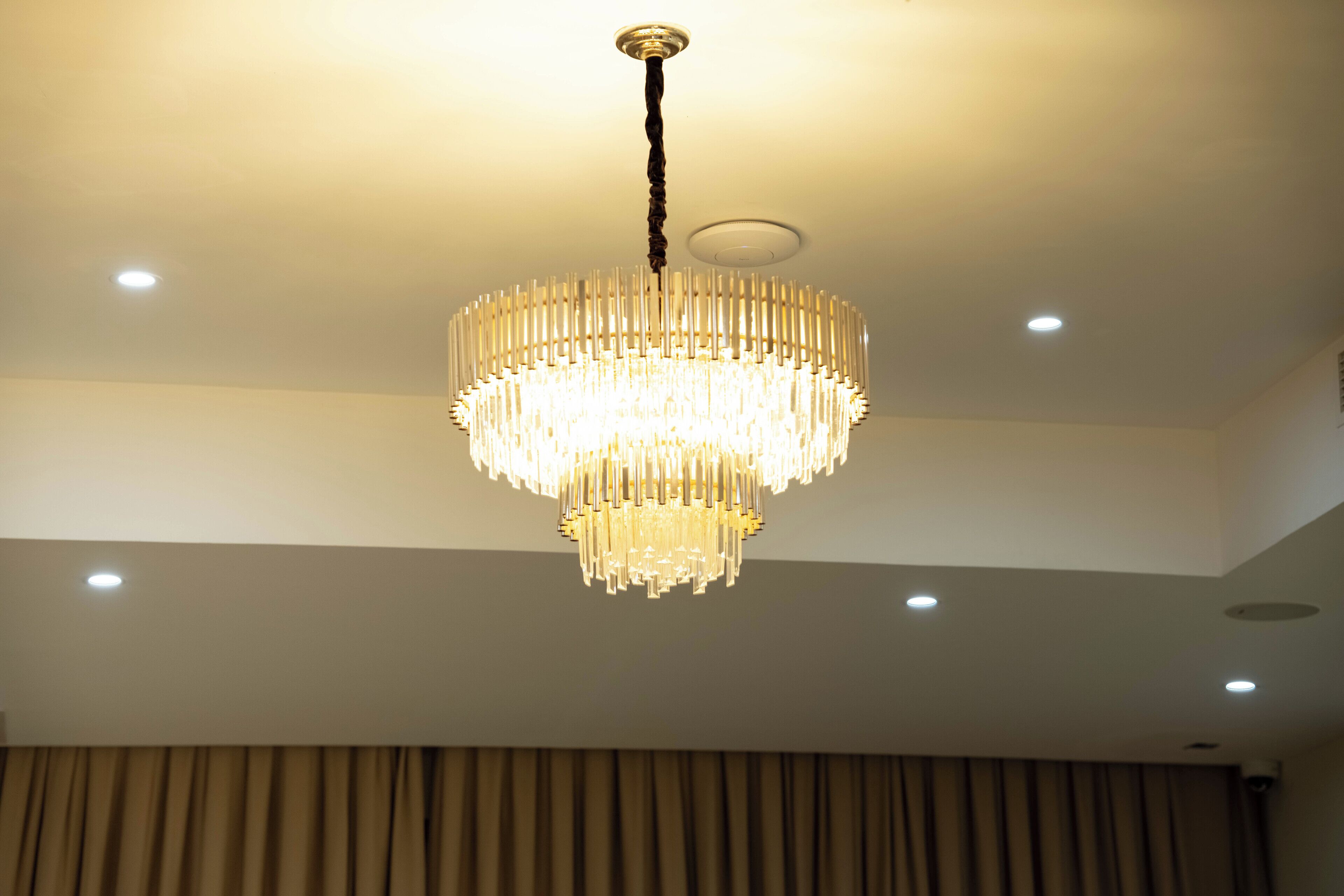 A chandelier with multiple tiers of light fixtures hanging from the ceiling.